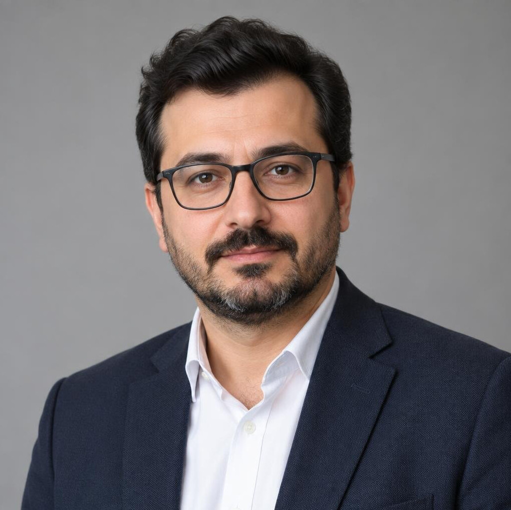 Studio portrait of a Turkish male economy editor with glasses